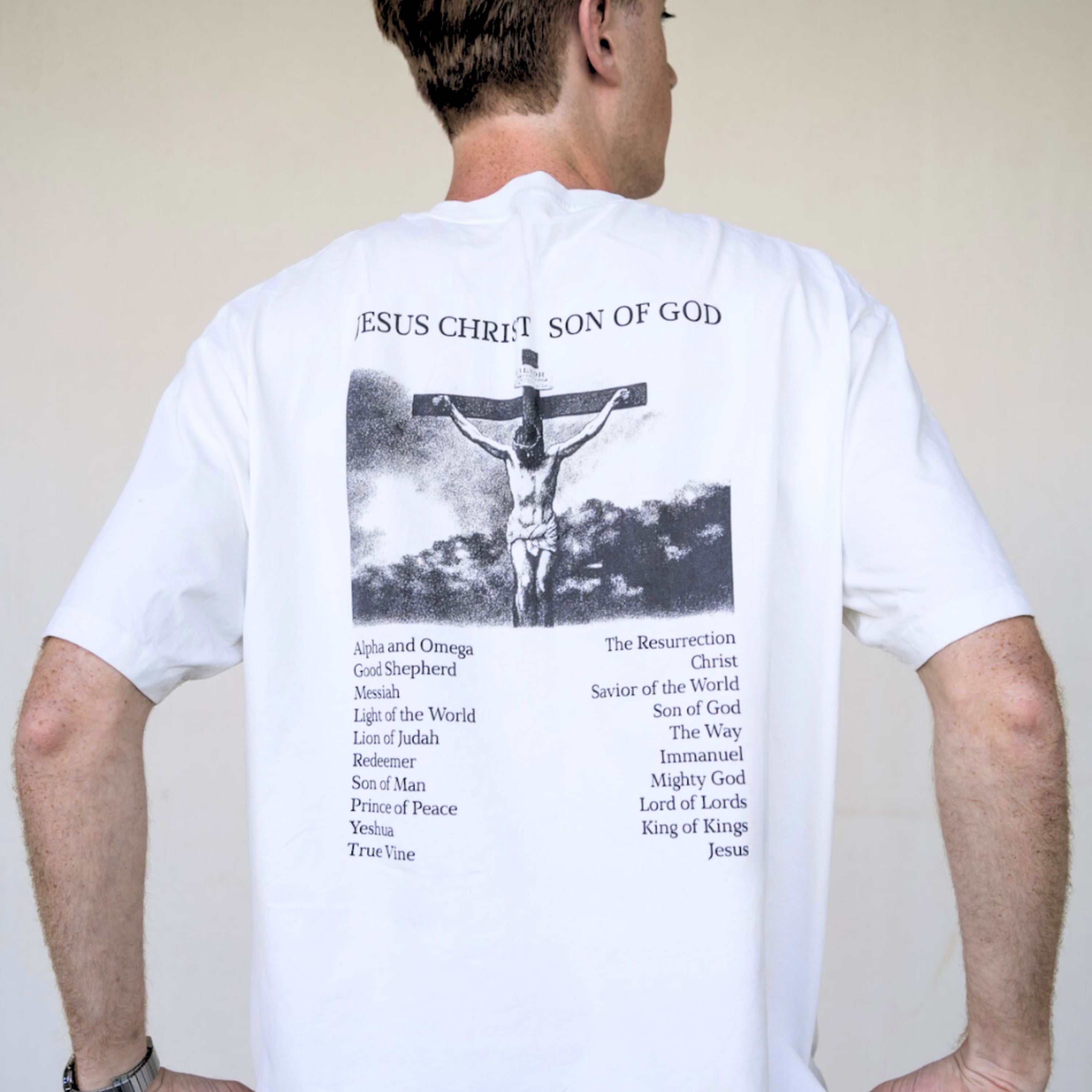 Full back view of white Christian t-shirt with large crucifixion print and “Jesus Christ Son of God” text.
