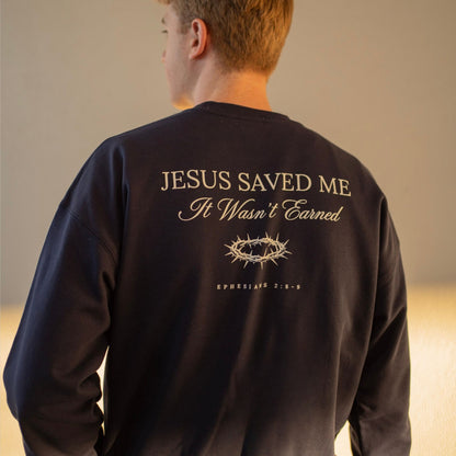 Person wearing a black sweatshirt with 'Jesus Saved Me, It Wasn't Earned' text on the back.