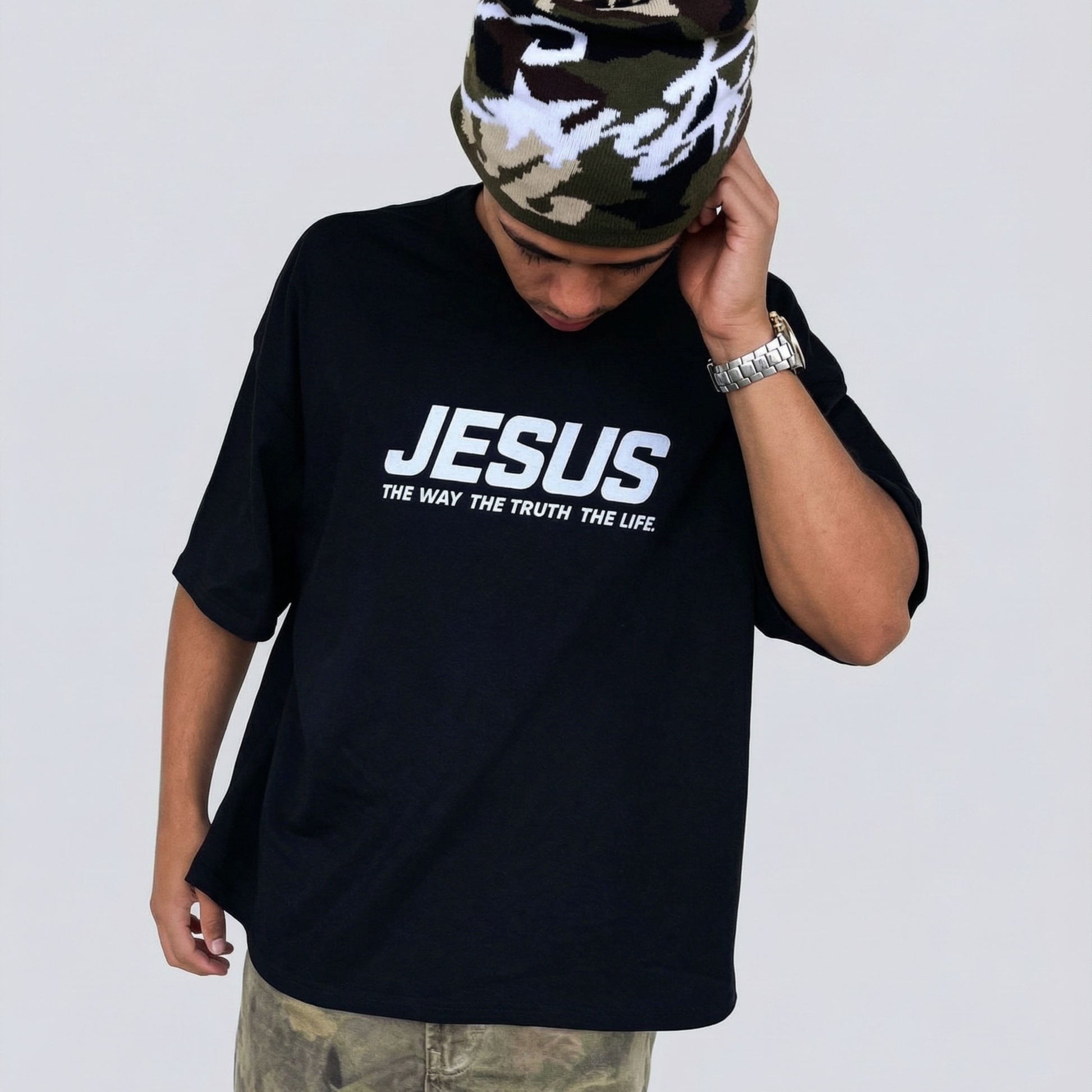 Lifestyle front view of a black Reconciled Collective Christian t-shirt with “JESUS The Way The Truth The Life” text design
