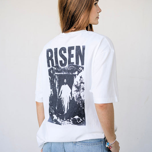 Back view of white oversized Christian streetwear t-shirt featuring large “Risen” graphic print by Reconciled Collective