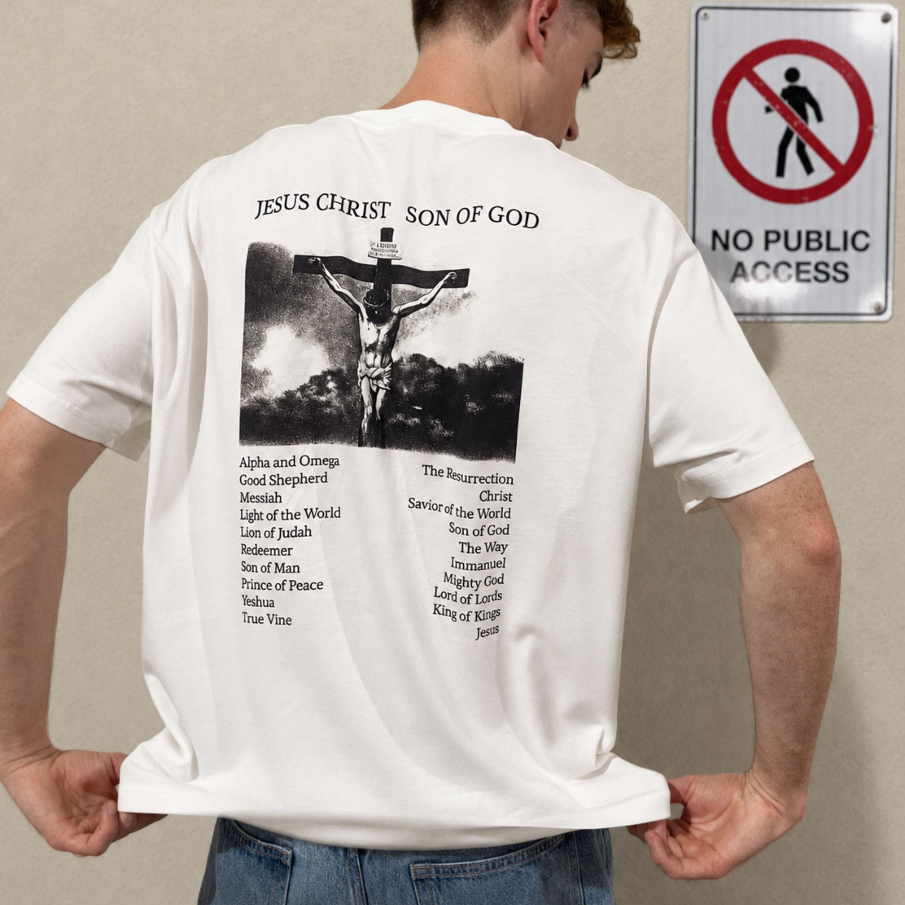 Person wearing a white t-shirt with religious graphic and text, standing next to a 'No Public Access' sign.